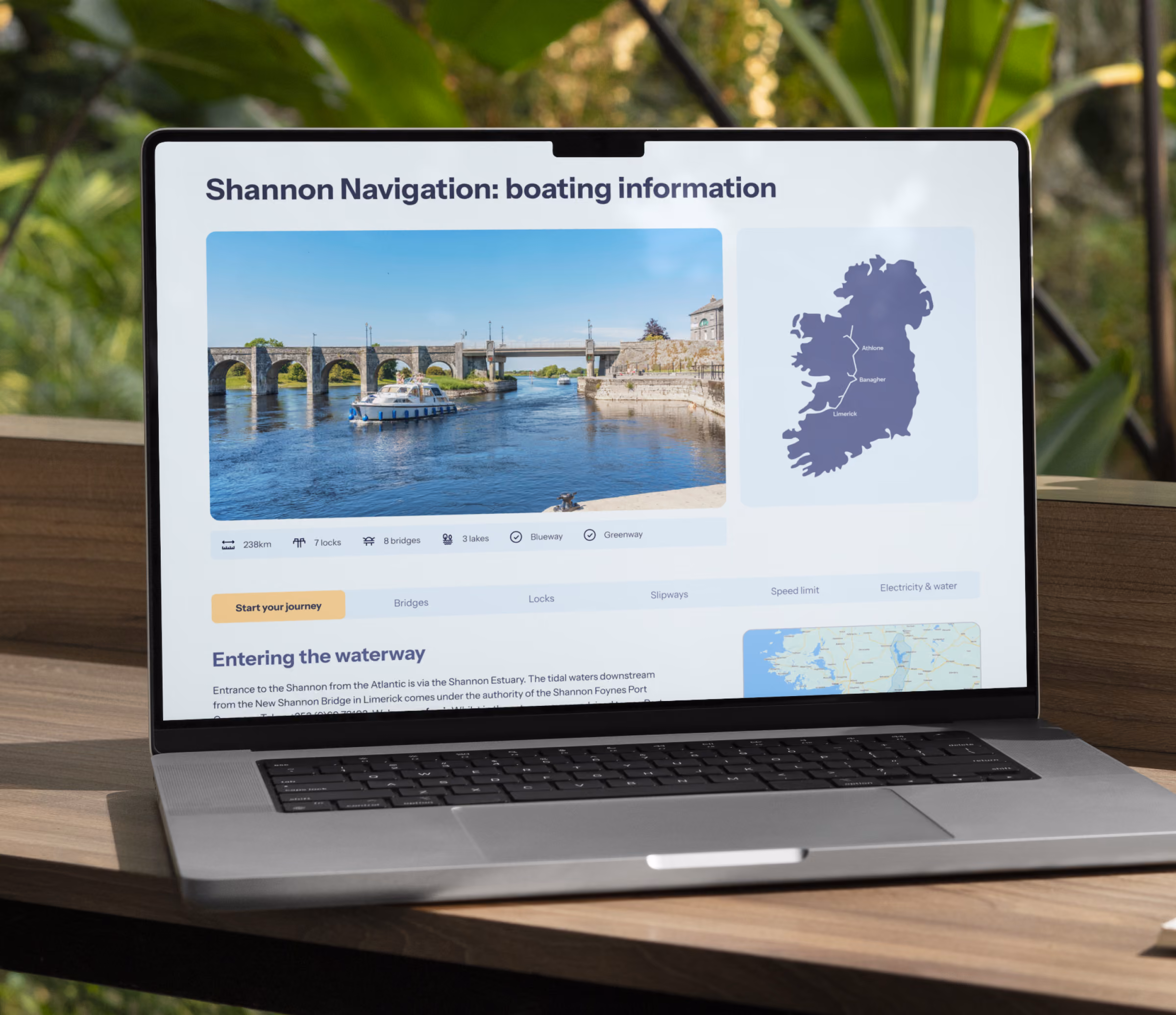 Laptop screen shows Shannon Navigation boating info with a river photo, map of Ireland, and travel details.